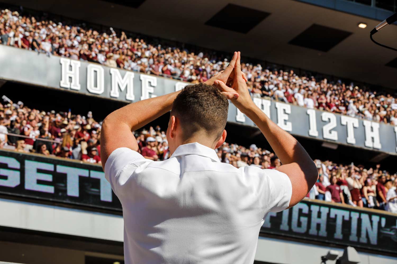 Texas A&M yell leader giving his wildcat at the end of a yell