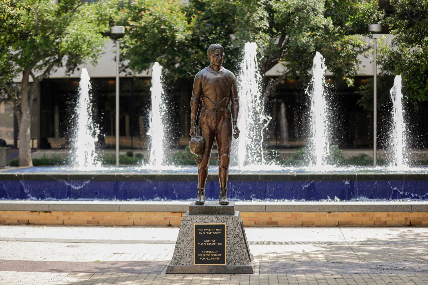 Statue of E. King Gill, known as the 12th Man Statue in front of a fountain in Rudder Plaza