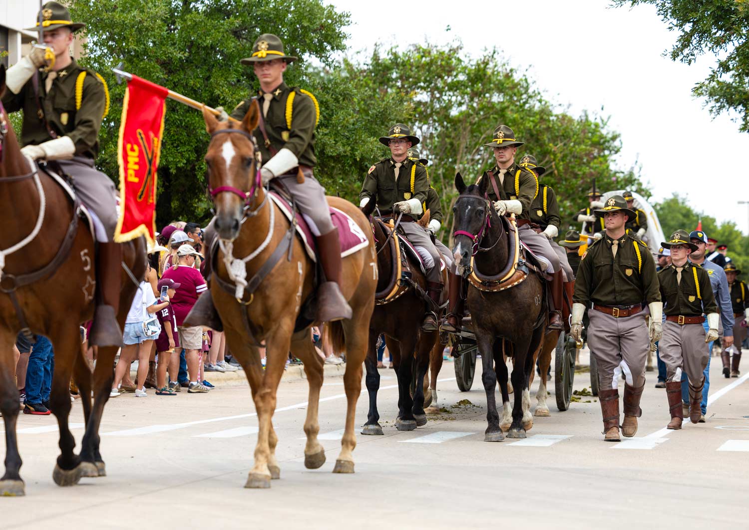 Members of Parsons Mounted Cavalry sit atop their horses as the Corps marches in on gameday